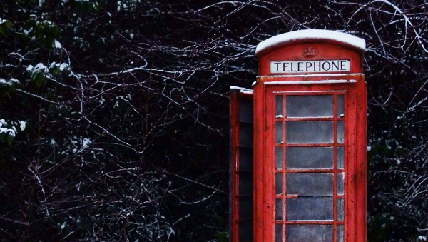 A British Telephone Booth is a slightly snow covered  country scene depicts team management requiring open communicaion