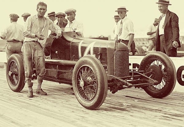 Old race car photo with exhausted driver depicting how business owners look if the they don't get second quarter awareness in the 2nd quarter.