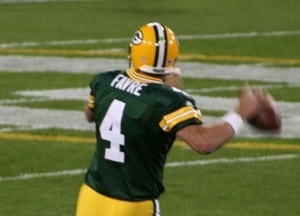 The back of Brett Favre as he is about to pass the football.