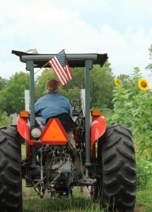 Customer Loyalty depicted by a farmer having an American Flag on the back on his tractor.