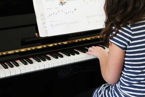 Consistent Actions iIllustrated by young girl practicing playing the piano. 