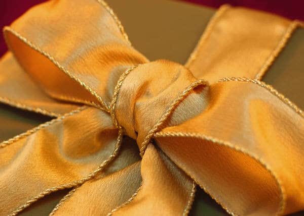 Business Productivity Tips are illustrated by a gift wrapped in a golden bow.