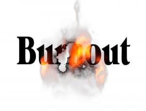 burnout image of words with flames and smoke representing overworked and exhausted